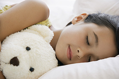Little Girl Sleeping with a Teddy Bear