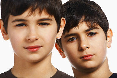 Twin boys (13-15), close-up, portrait